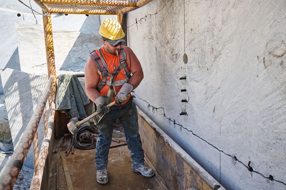 A Construction worker wearing Chippewa work boots while working on a construction site.